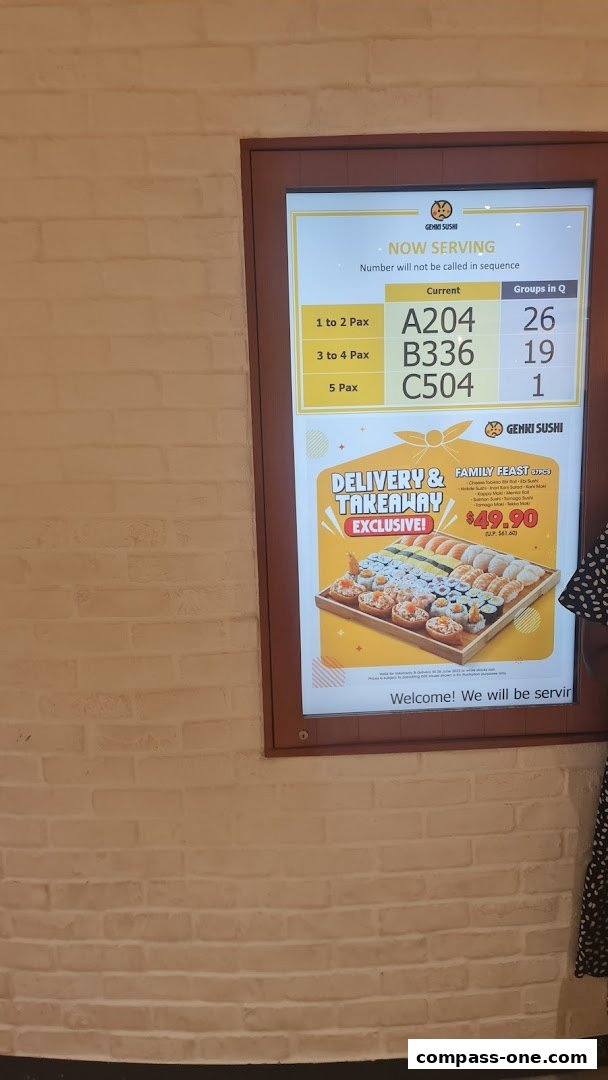 A digital display shows current queue numbers and a family feast sushi platter for delivery and takeaway.