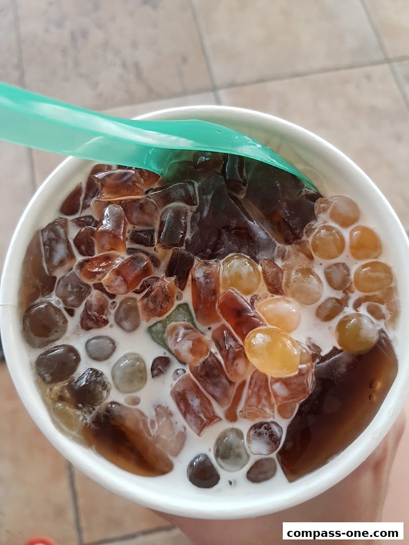 A refreshing dessert with jelly cubes and tapioca pearls in milk.