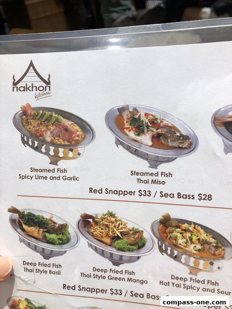 A menu from Nakhon Kitchen featuring various steamed and deep-fried fish dishes with prices.