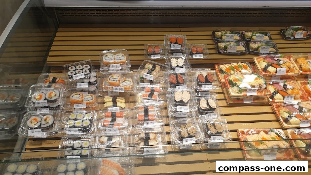 A display of various pre-packaged sushi rolls and nigiri in clear plastic containers.