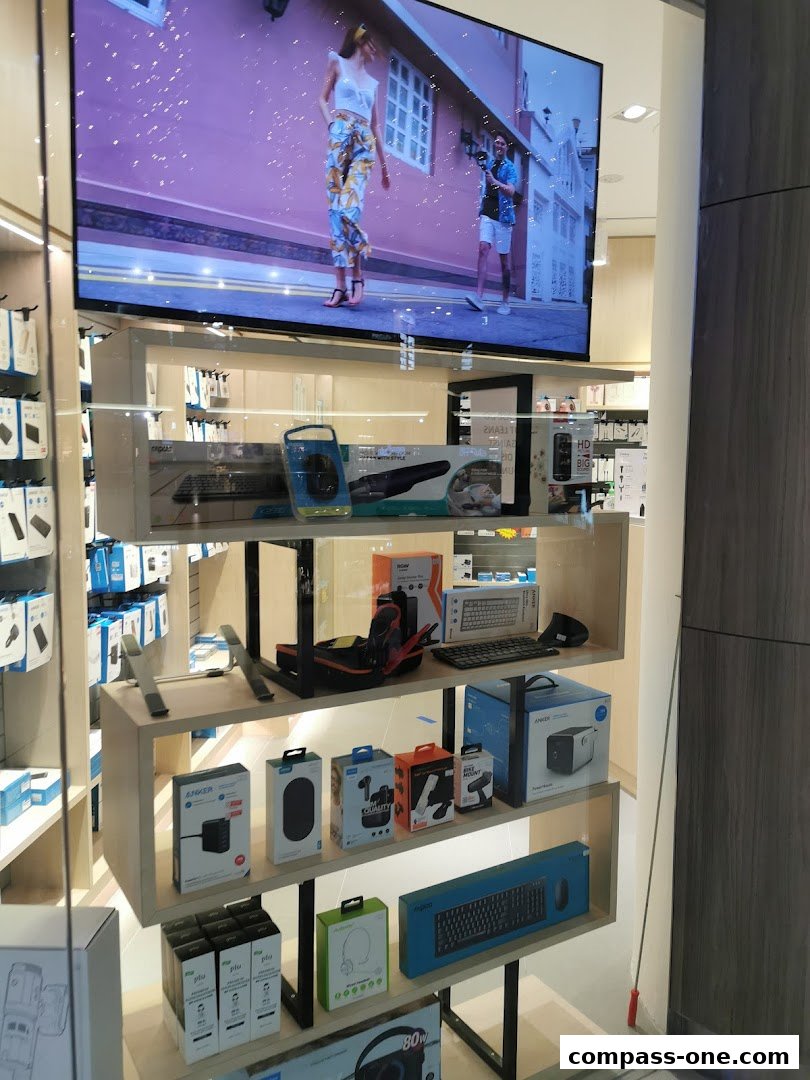 A display window showcasing various tech accessories and electronics, including keyboards, chargers, and headphones.