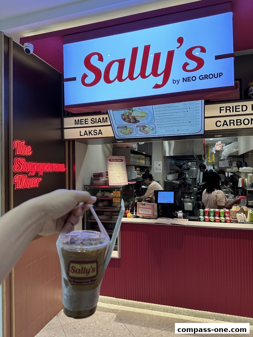 A hand holds a takeaway drink in front of Sally's, a Singaporean diner.