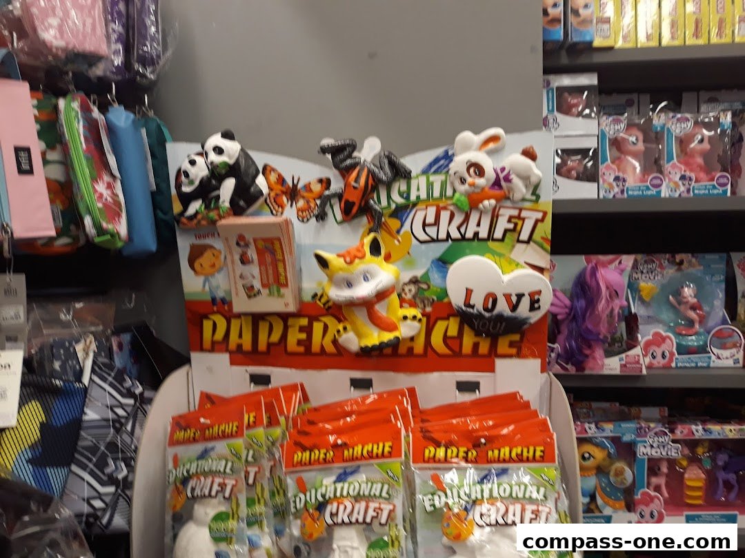 A display of craft kits and toys, including paper mache kits and My Little Pony figures.