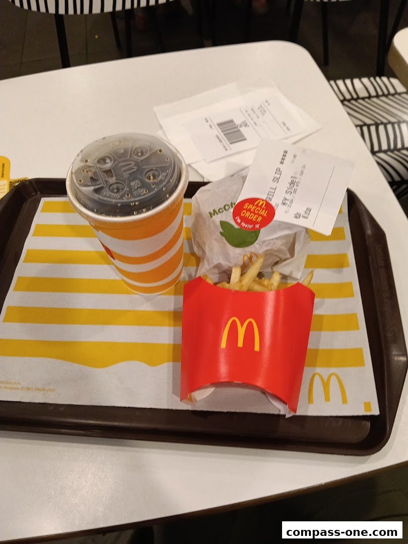 A McDonald's meal featuring a burger, fries, and a drink on a tray.