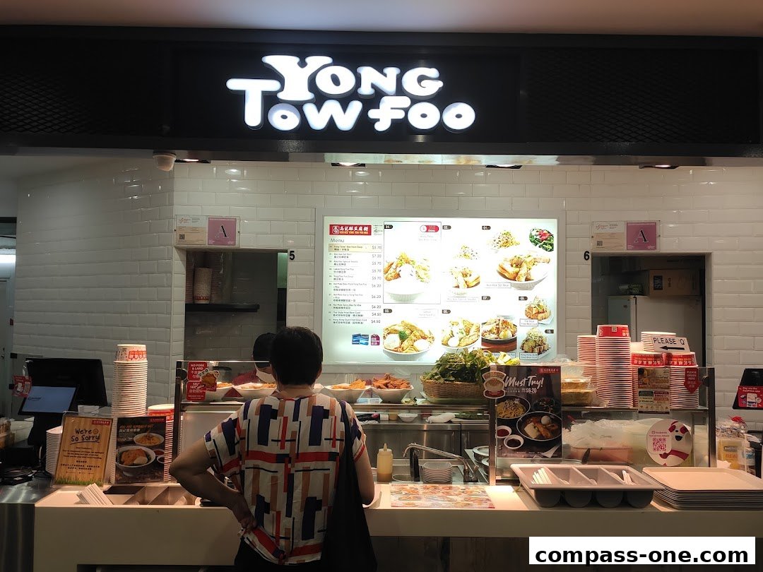 A customer stands at the counter of Koo Kee Yong Tow Foo Mee, looking at the menu.