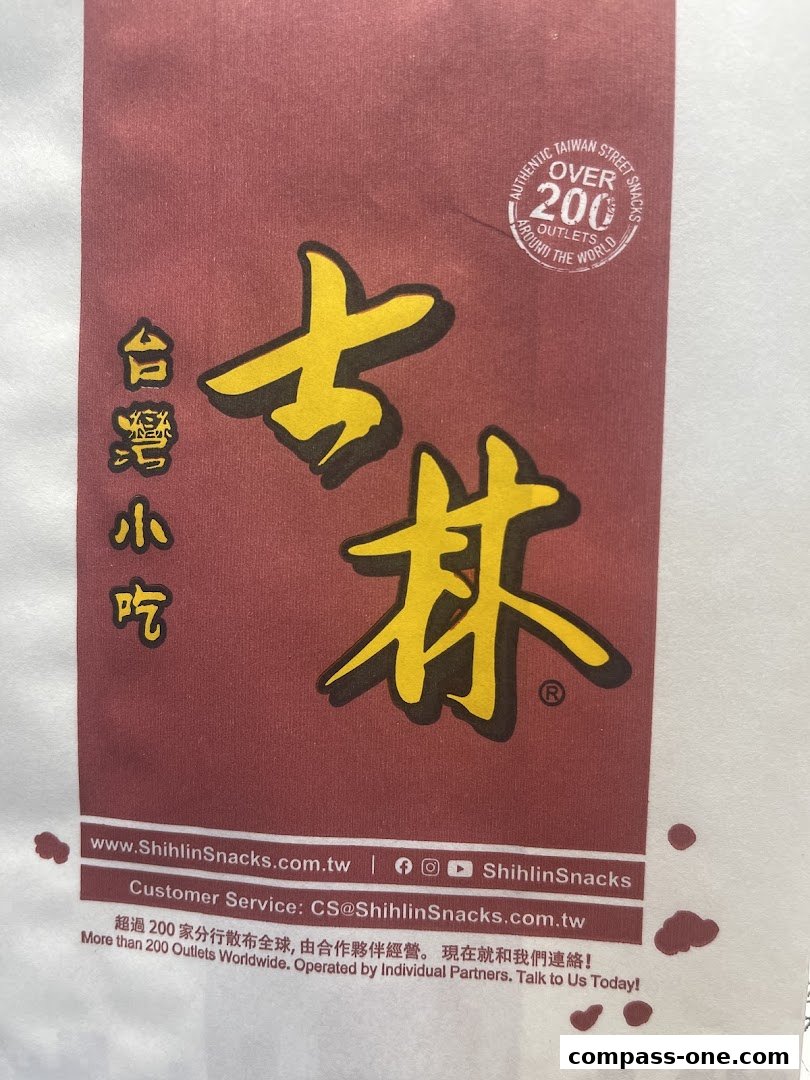 A close-up of a Shihlin Taiwan Street Snacks bag with prominent branding and contact information.