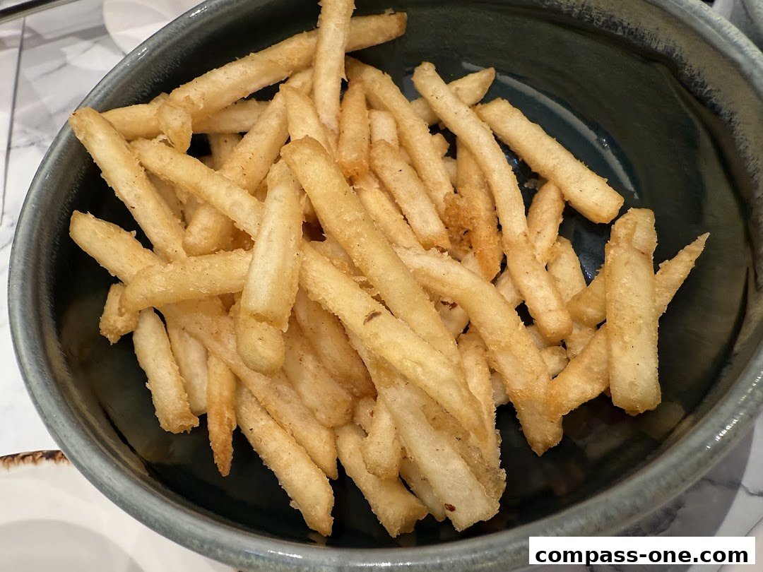 A close-up shot of a bowl filled with golden-brown french fries.