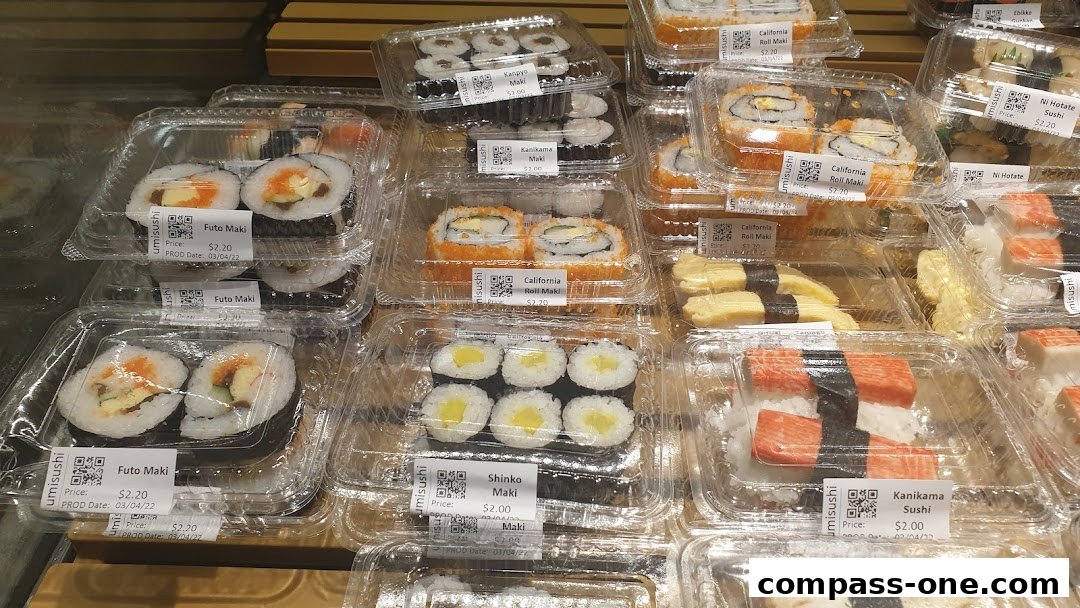 A variety of pre-packaged sushi rolls and nigiri in clear plastic containers.