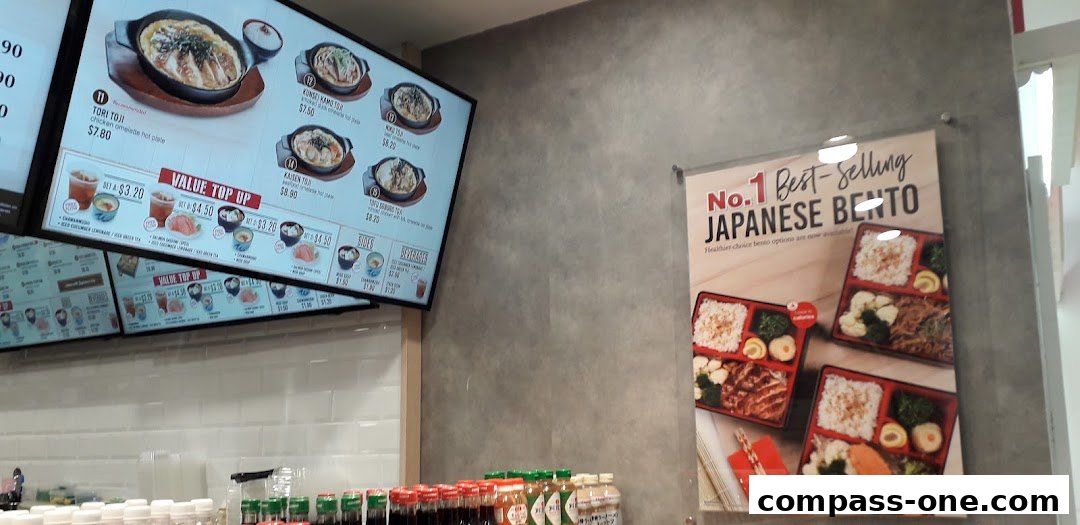 Digital menu boards displaying Japanese food items and value top-up options.