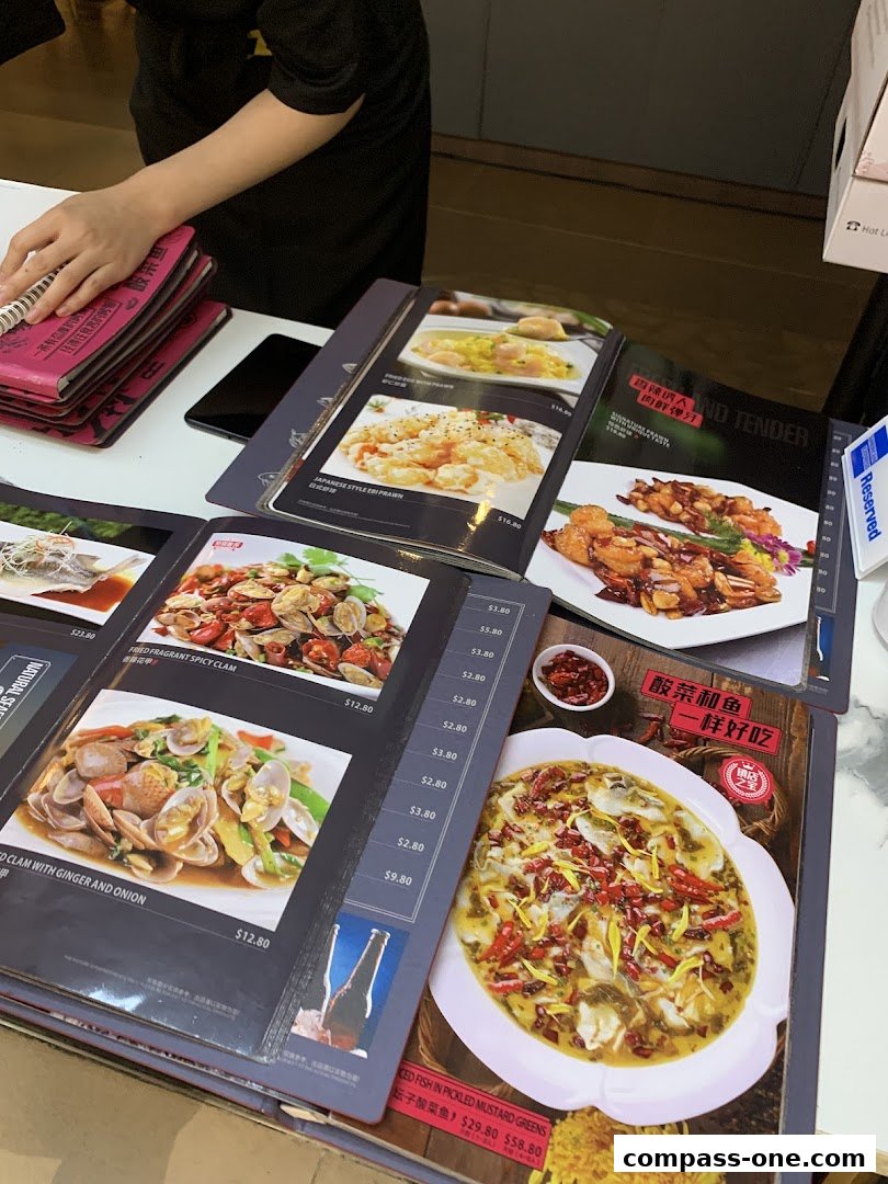 A selection of menus from Fu Qi Grilled Fish, showcasing various seafood dishes.