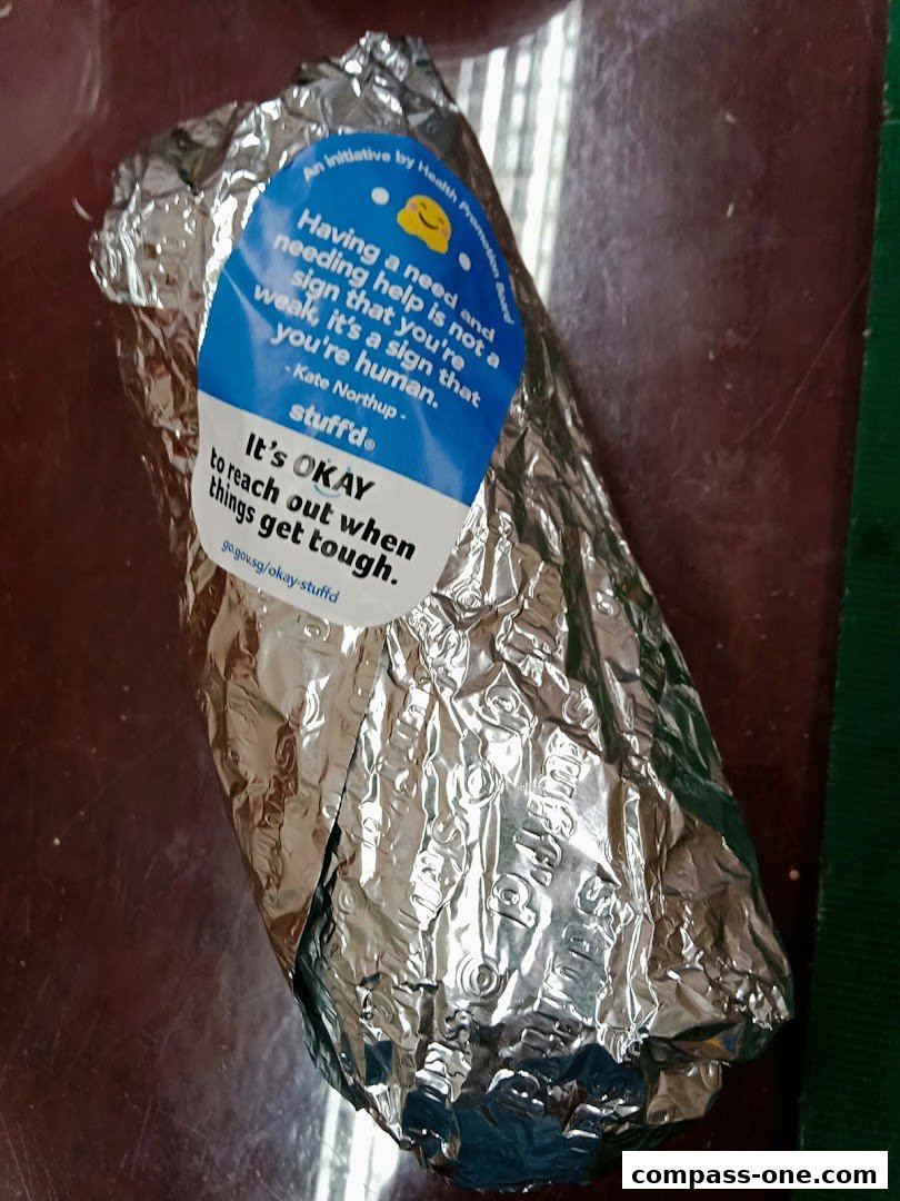 A foil-wrapped food item with a sticker promoting mental well-being.