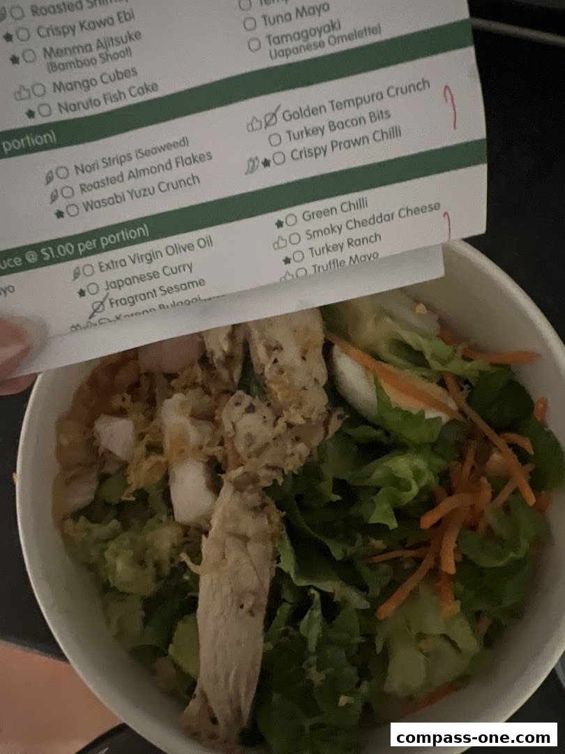 A close-up of a menu with various food items and toppings for a salad or bowl.