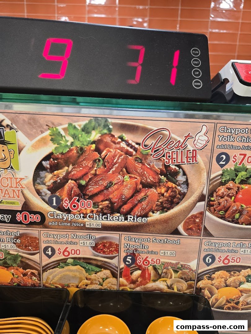 A display of various claypot dishes offered at Encik Tan, featuring appetizing food photography.