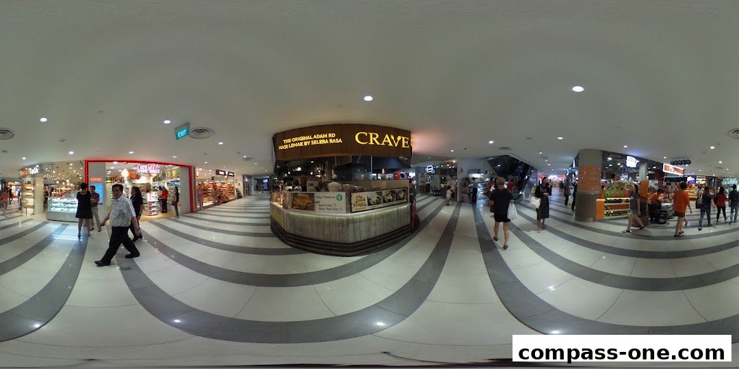 A panoramic view of a shopping mall corridor with the Crave Nasi Lemak shop prominently featured.