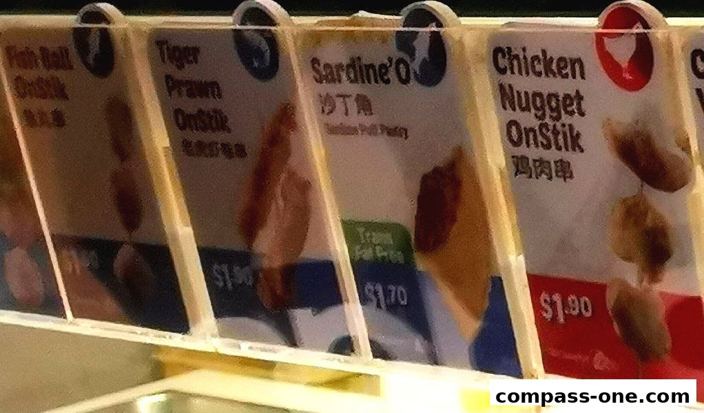 A close-up of various Old Chang Kee snacks on sticks with prices displayed.