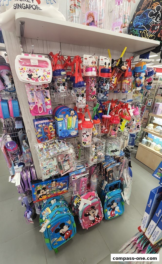 A display of Disney-themed stationery and school supplies, including backpacks, water bottles, and lunch boxes.