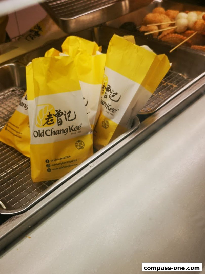 Yellow paper bags with the Old Chang Kee logo and social media handles.