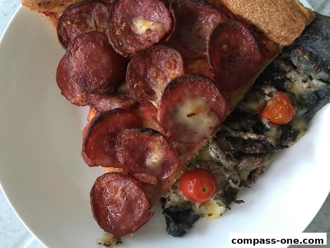 A close-up shot of two slices of pizza with pepperoni and mushrooms on a white plate.