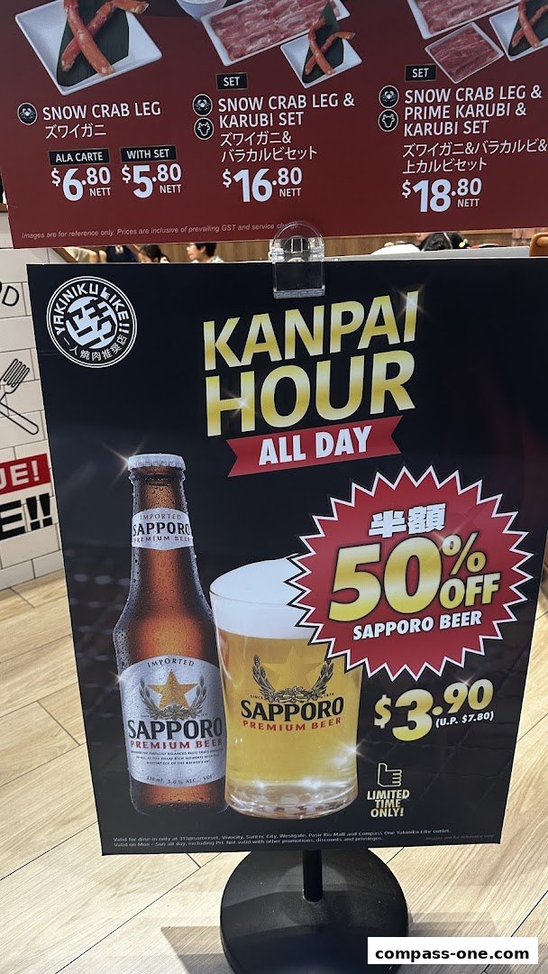 A sign advertising a Kanpai Hour promotion with 50% off Sapporo beer.