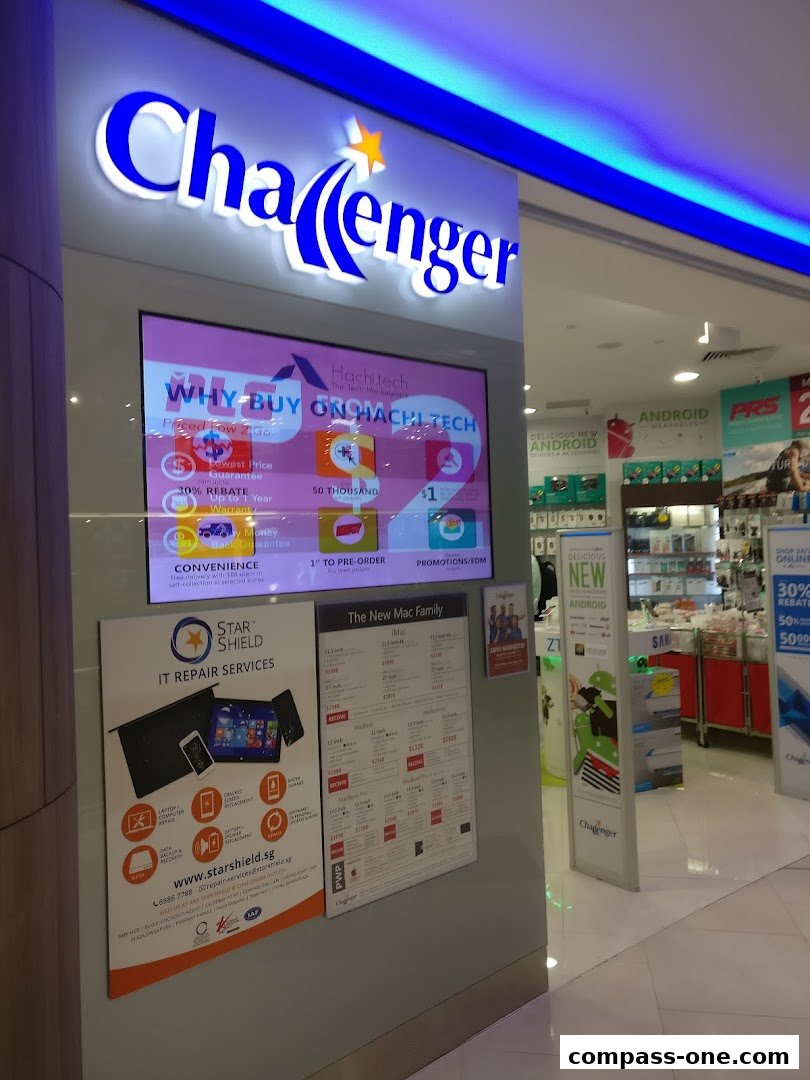 The Challenger electronics store entrance with a digital display and promotional posters.