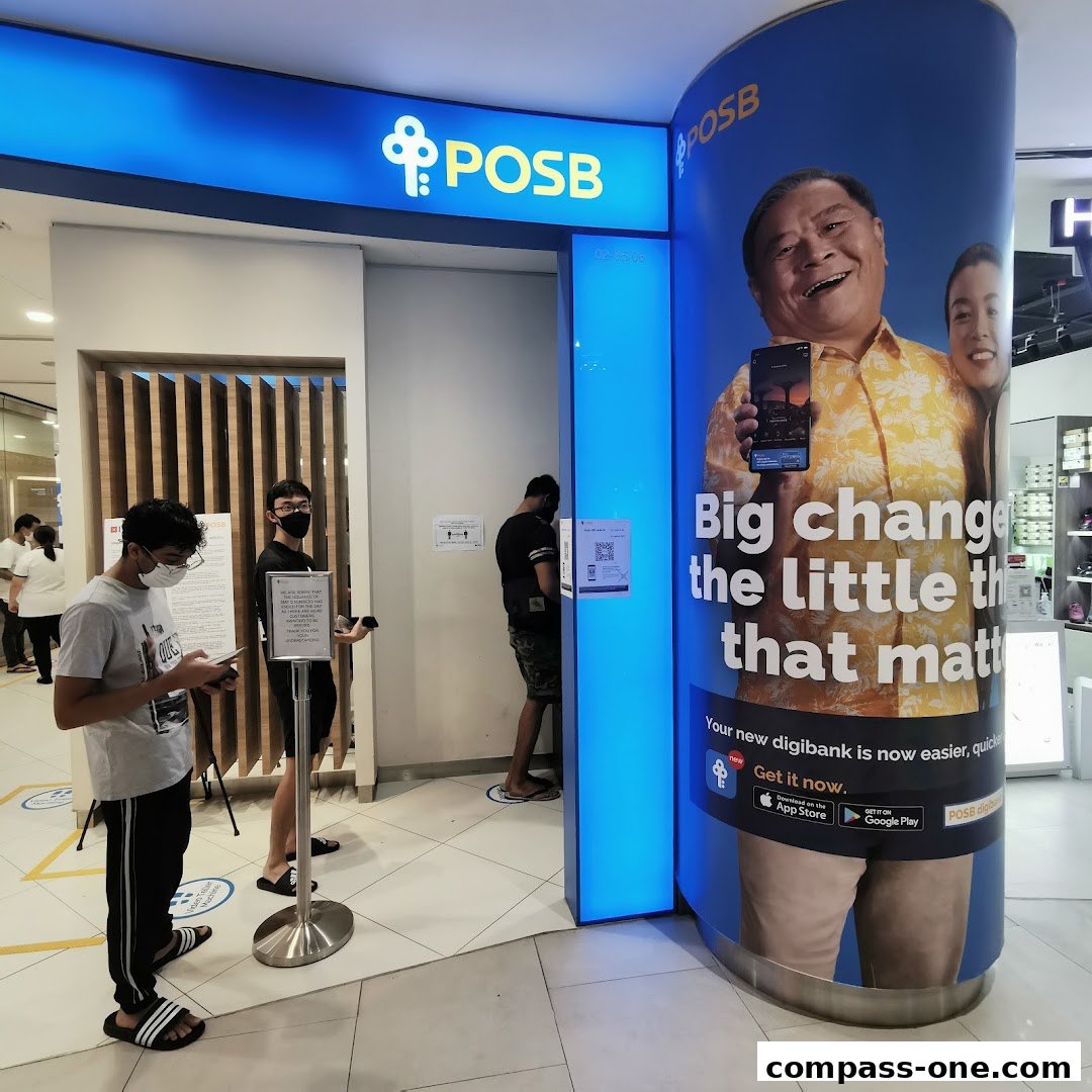 People queue outside a POSB bank branch with a large advertisement for their digibank.