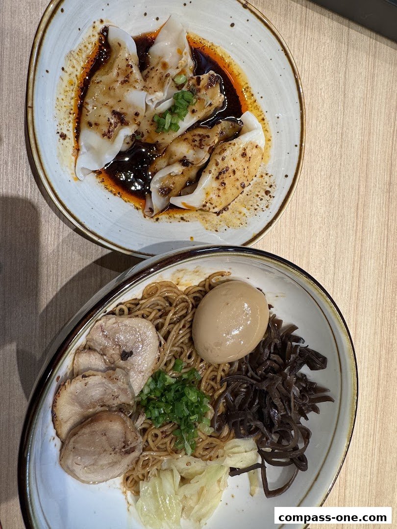 A close-up shot of two bowls of delicious ramen and dumplings, showcasing fresh ingredients.