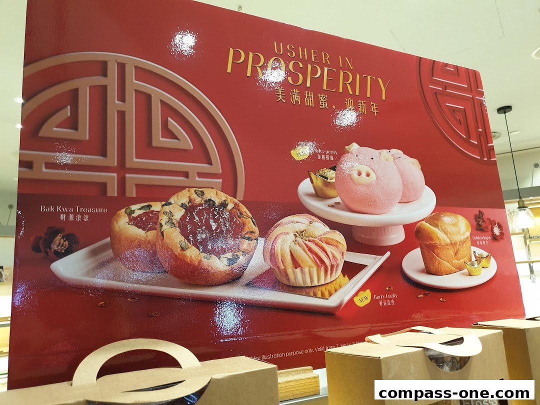 A festive red display board from BreadTalk showcasing various baked goods and a Chinese New Year theme.