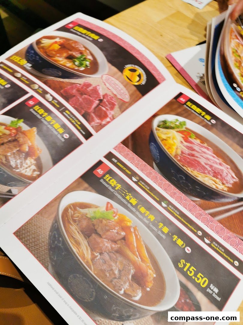 A close-up of a menu from LeNu Chefs Wai Noodle Bar featuring various beef noodle dishes.