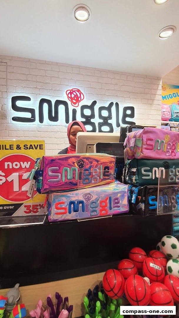 A Smiggle store counter displaying colorful pencil cases and promotional signage.