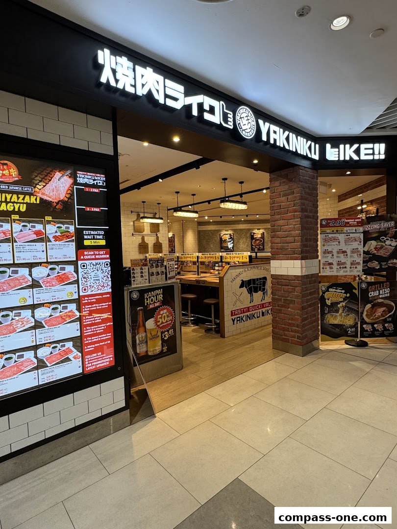 The entrance to Yakiniku Like restaurant, showcasing its signage and a menu display.