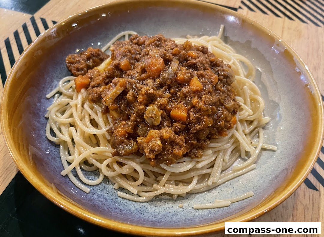 A close-up shot of spaghetti bolognese served in a rustic bowl.