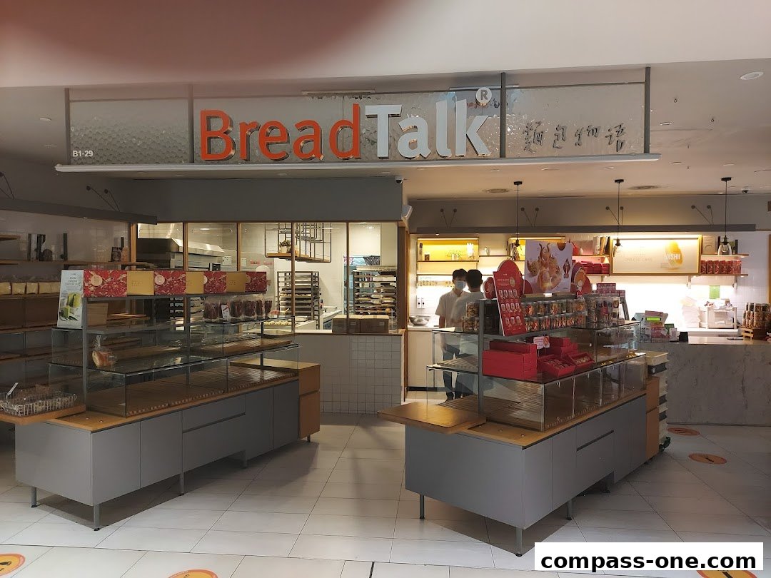 Interior view of a BreadTalk bakery with display cases and staff.