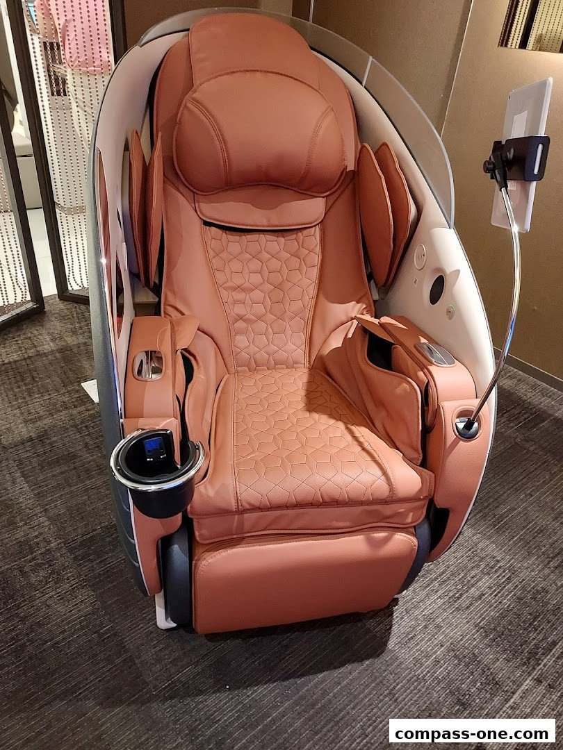 A luxurious, modern massage chair with a built-in tablet holder and cup holder.