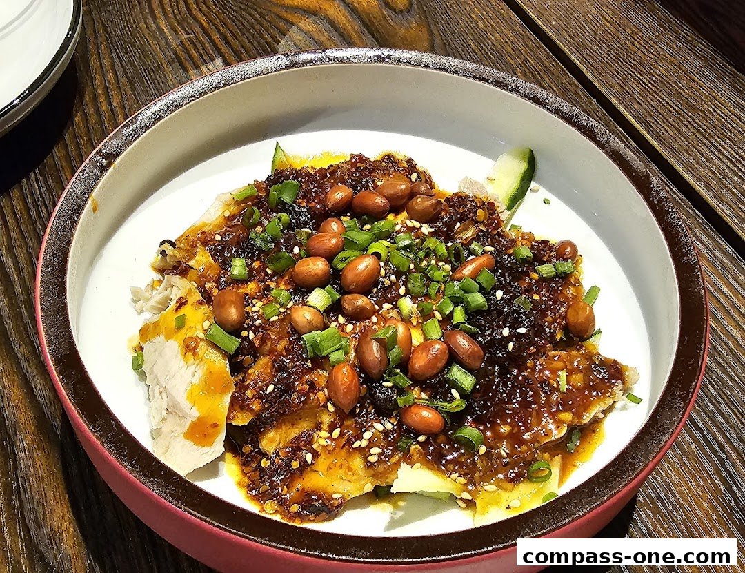 A close-up of a delicious dish with grilled fish, peanuts, and chili sauce.