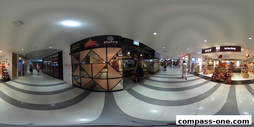 A panoramic view of a shopping mall corridor with several shops, including Crave Nasi Lemak and Eu Yan Sang.