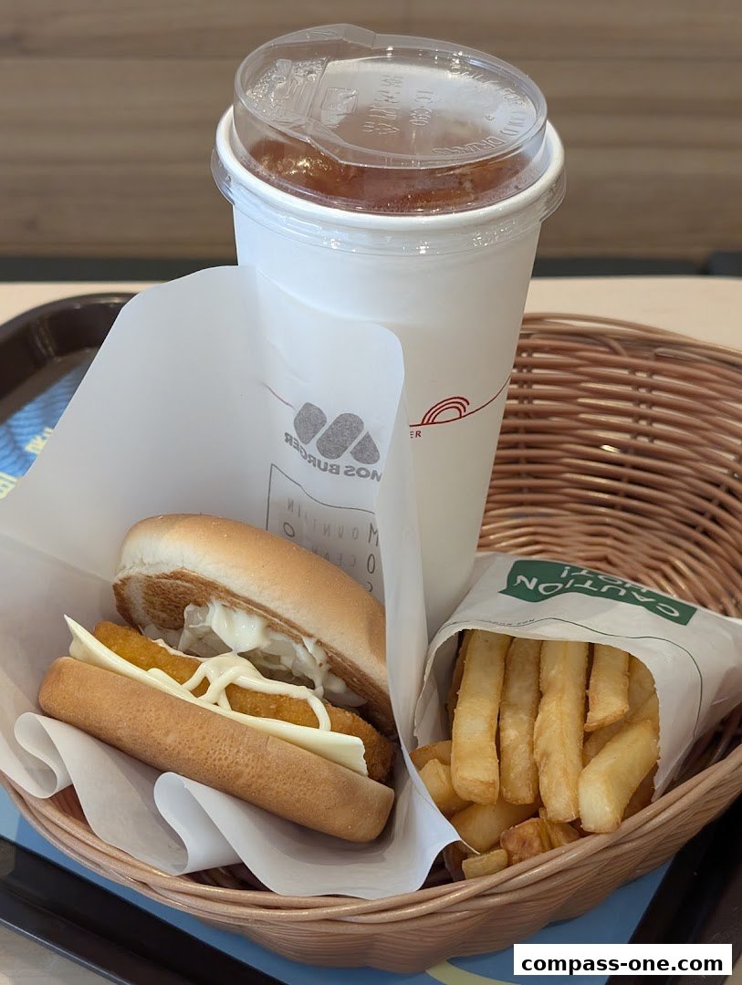 A MOS Burger meal featuring a fish burger, fries, and a drink in a basket.