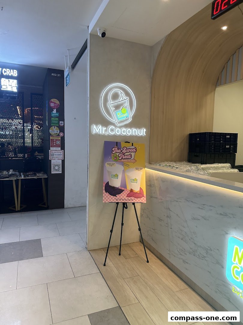 The Mr. Coconut shop front with its logo and a promotional stand.