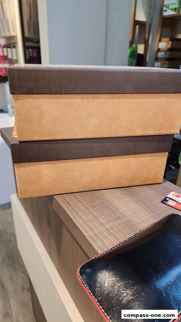 Stacked shoe boxes with textured brown and tan finishes on a wooden counter.