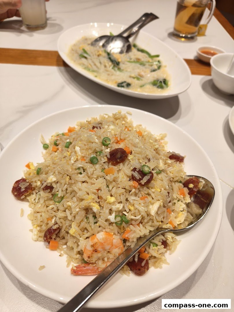 A close-up of a delicious fried rice dish with shrimp and sausage, served at White Restaurant.