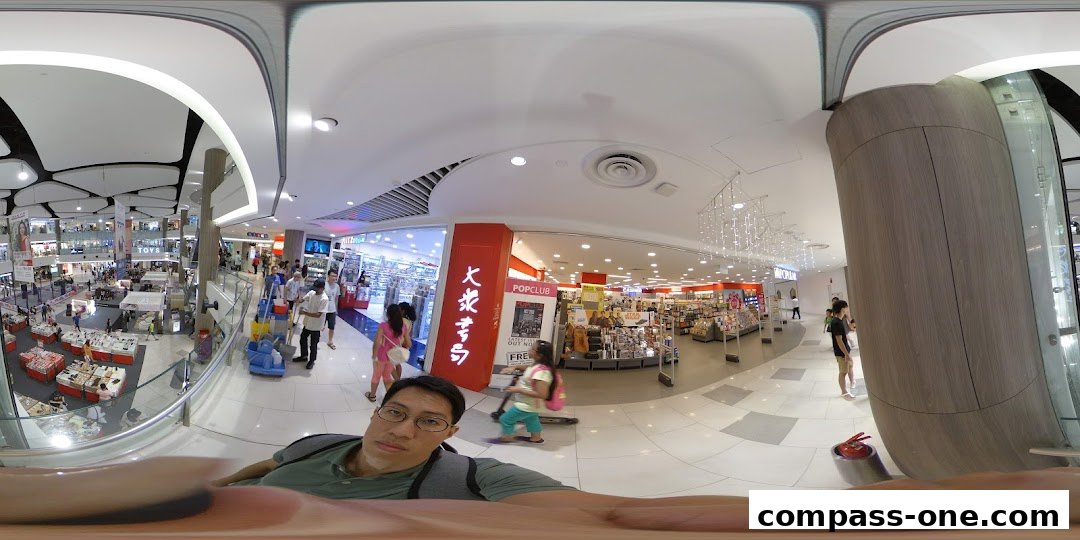 Interior view of a busy POPULAR Bookstore with customers browsing shelves and displays.
