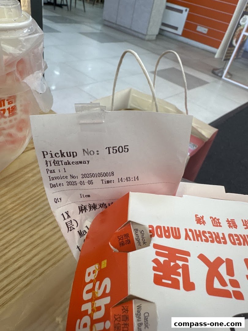 A receipt and burger packaging from Shiok Burger, indicating a takeaway order.