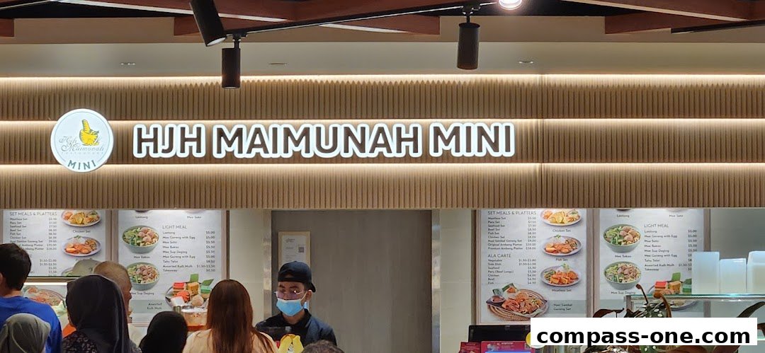 A food stall with a menu displaying various set meals, light meals, and ala carte options.