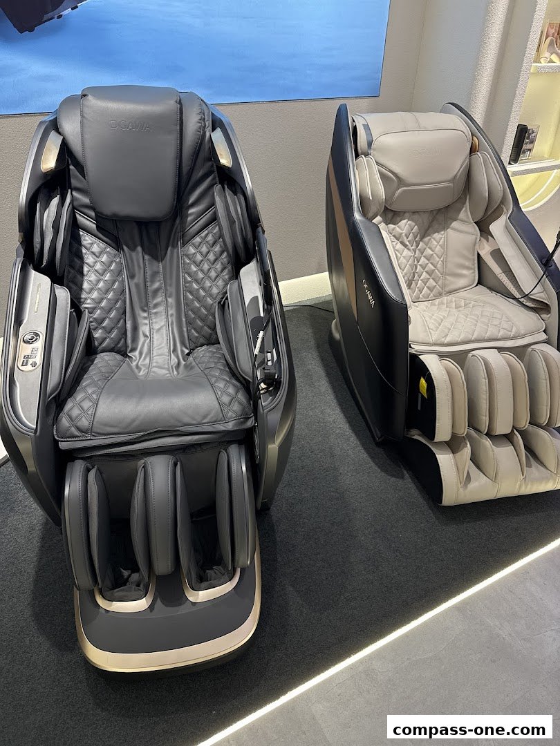 Two luxurious OGAWA massage chairs are displayed in a modern retail setting.