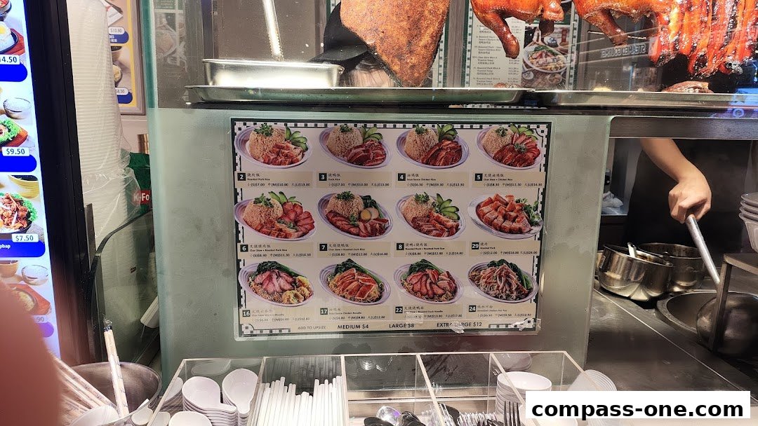 A menu board displaying various roasted meat rice dishes and noodle dishes with prices.