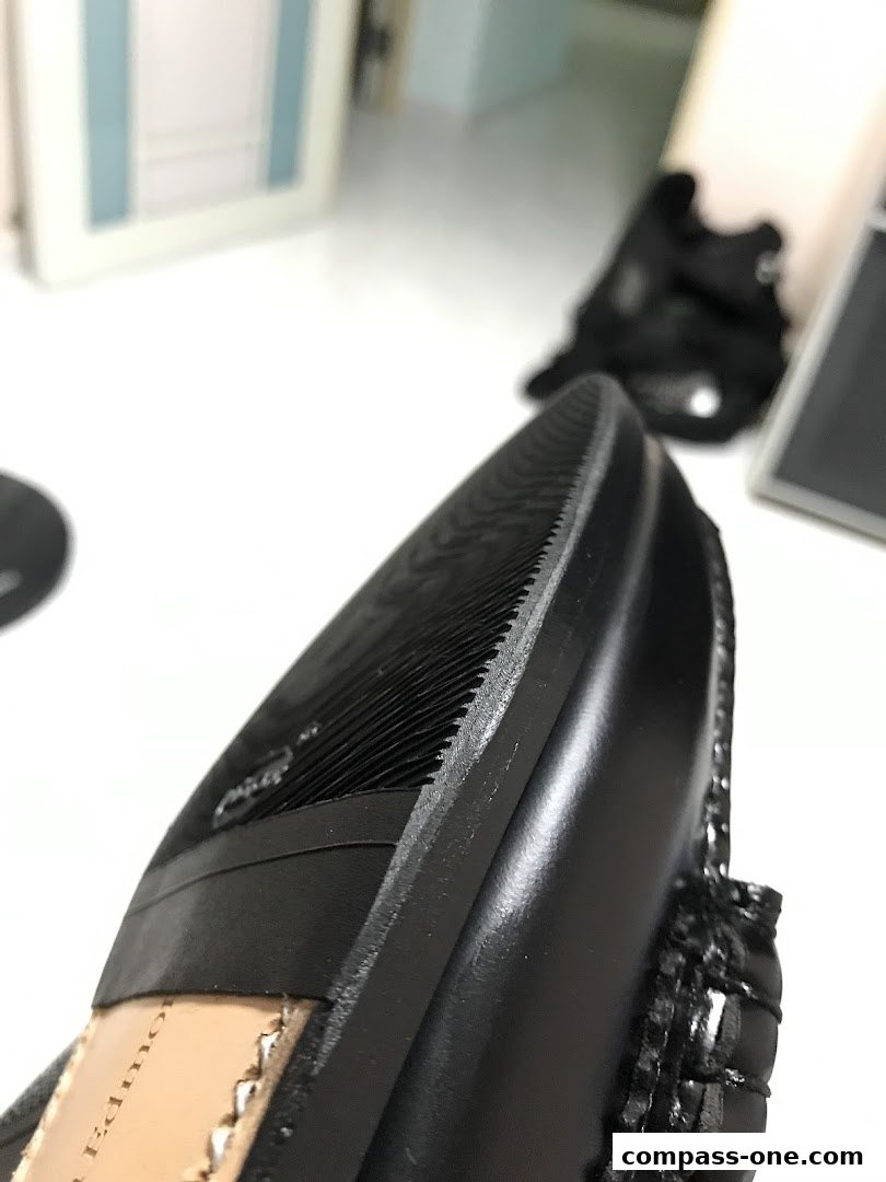 Close-up view of the sole and heel of a black leather shoe.