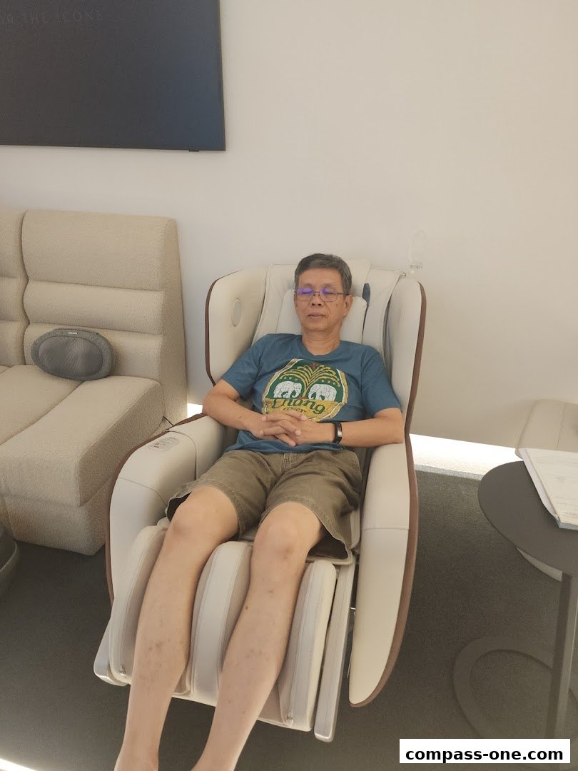 A man relaxes in a massage chair at OGAWA Compass One.