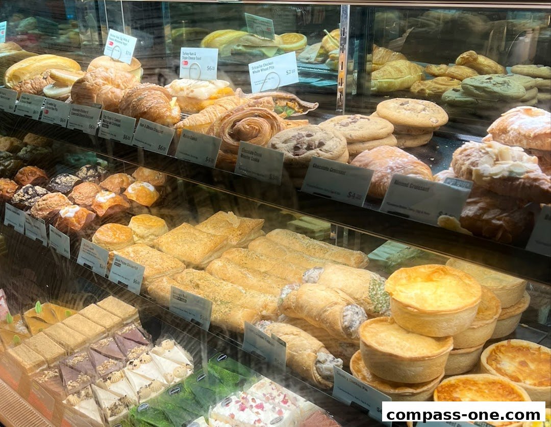 A display case filled with a variety of pastries, cookies, cakes, and savory pies.