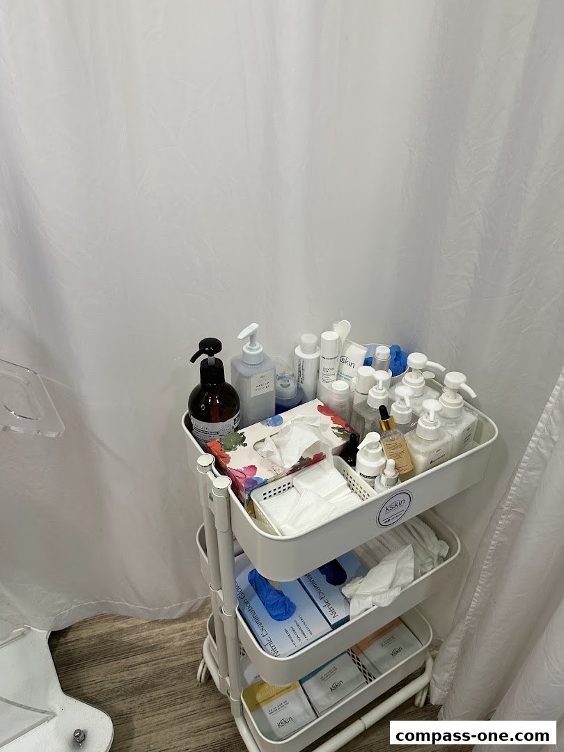 A three-tiered cart filled with various skincare products and supplies.