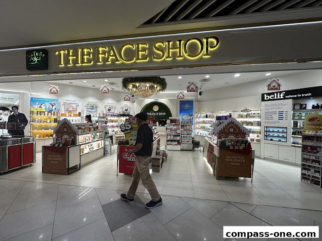 The interior of a brightly lit beauty store with displays of skincare products and holiday decorations.
