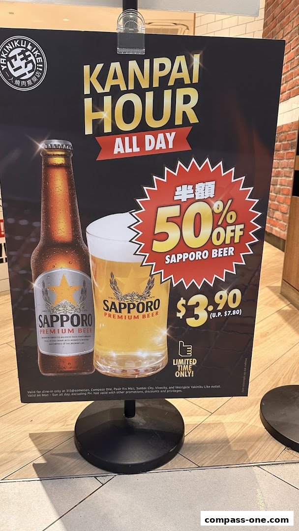 A sign advertising a Kanpai Hour special with 50% off Sapporo beer.